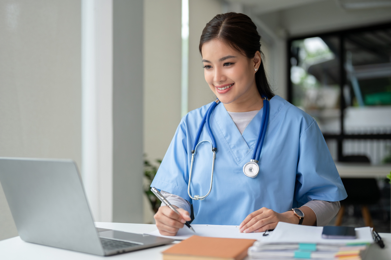 Nurse Working on a Laptop in an Office.