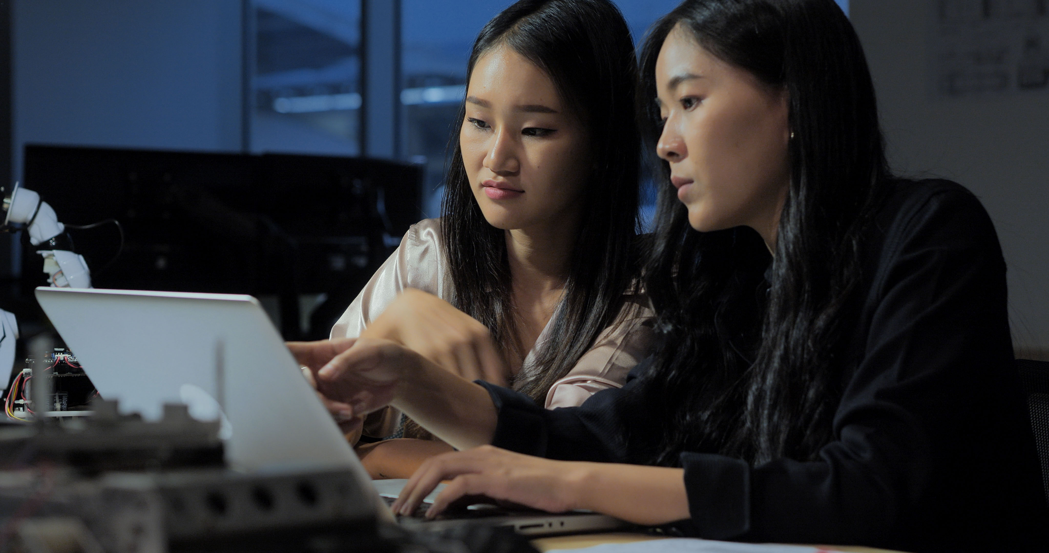 Students working on a laptop together.