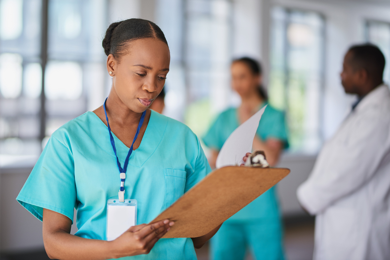 A Nurse Takes Notes on a Clipboard..jpg