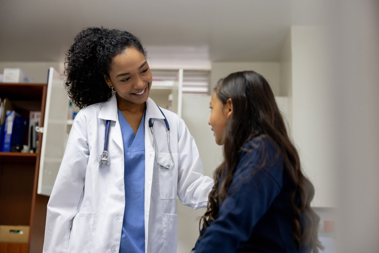 A Smiling Family Nurse Practitioner Treats a Child in a Medical Office..jpg
