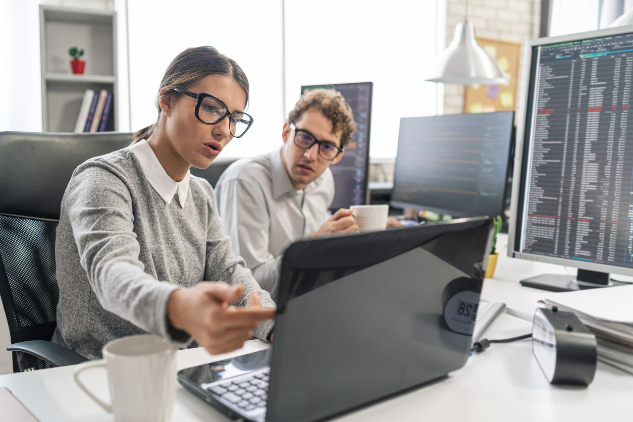 Two Cybersecurity Engineers Discussing a System Vulnerability.
