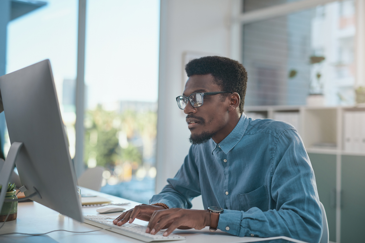 A Cybersecurity Professional Works at Their Computer..jpg