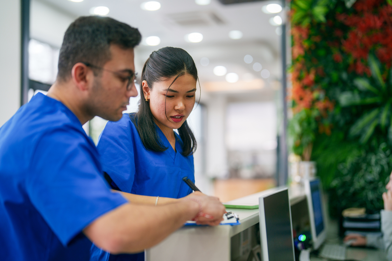 Nurses reviewing some paperwork in a health care clinic.
