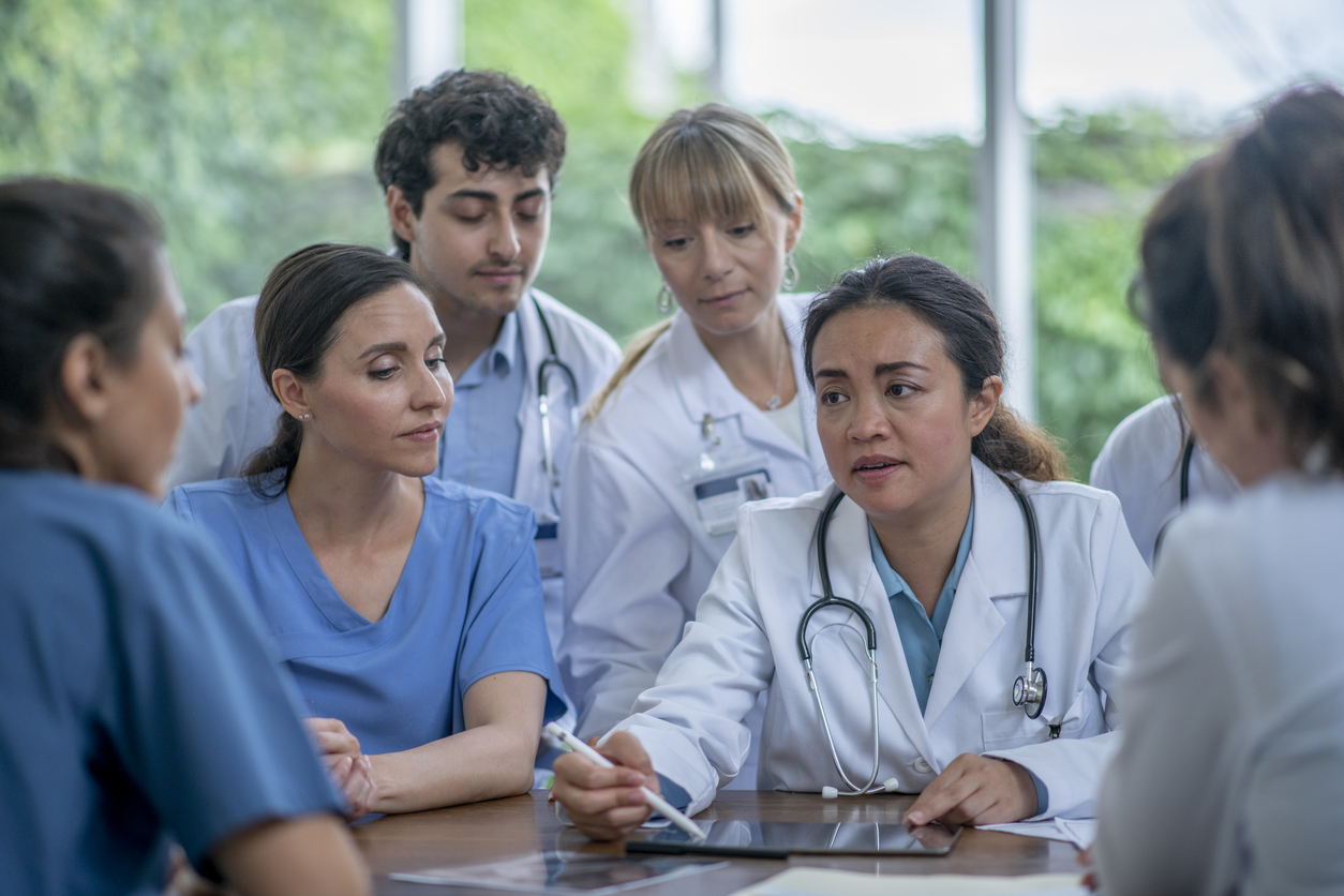 Advanced practice nurse in a meeting with colleagues. 