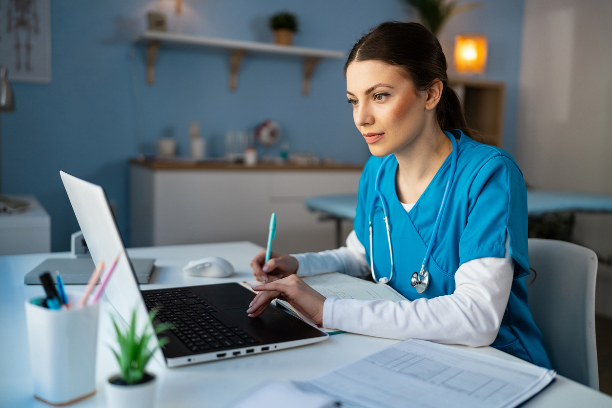 A Nurse Works on a Laptop..jpg