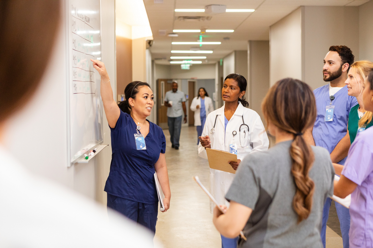 A Nurse Leader Goes Over the Schedule With the Health Care Team..jpg
