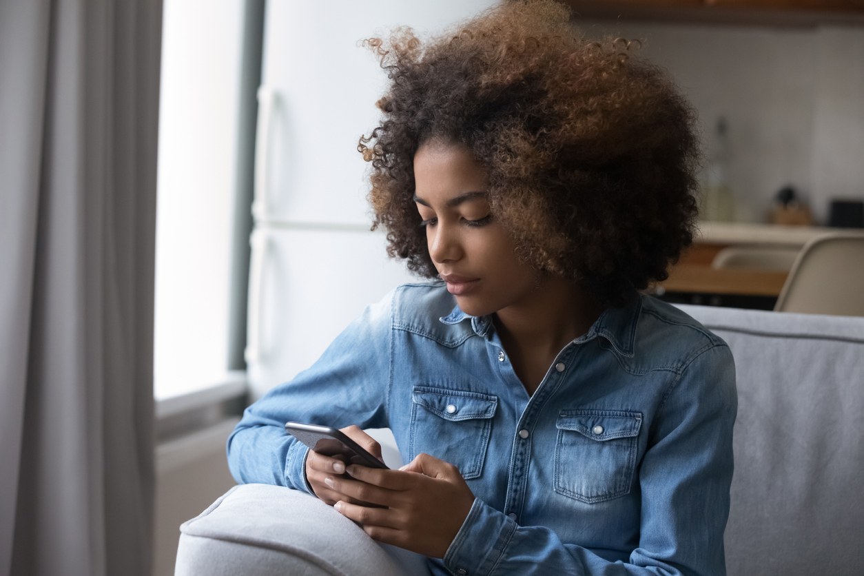 A Teen Uses a Smartphone.